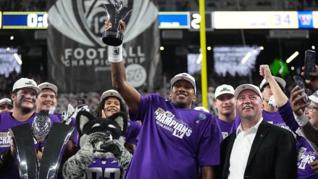 Troy Dannen, right, stands with UW quarterback Michael Penix Jr. after the Sugar Bowl victory.